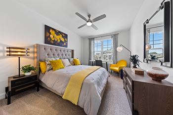 A bedroom with a large bed and a ceiling fan at Views at Flowers Apartments, Clayton, North Carolina