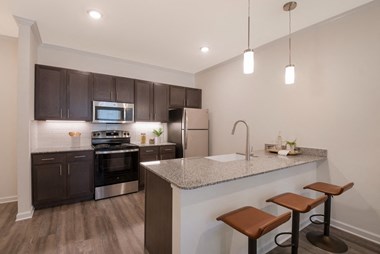 the heights at 4300 apartments | kitchen with granite counter top and stainless steel appliances  at Ardmore at Bryton, Huntersville, North Carolina - Photo Gallery 5