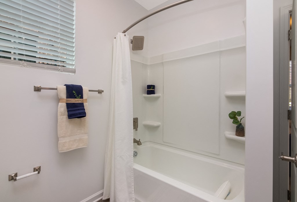 a bathtub and shower in a 555 waverly unit  at Ardmore at Bryton, Huntersville, North Carolina