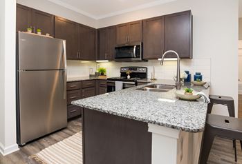 kitchen with granite countertops at the enclave at woodbridge apartments in sugar land, tx  at Ardmore at Bryton, Huntersville, North Carolina