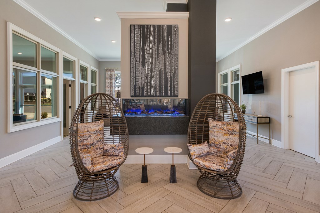 two chairs in front of a fireplace in a lobby