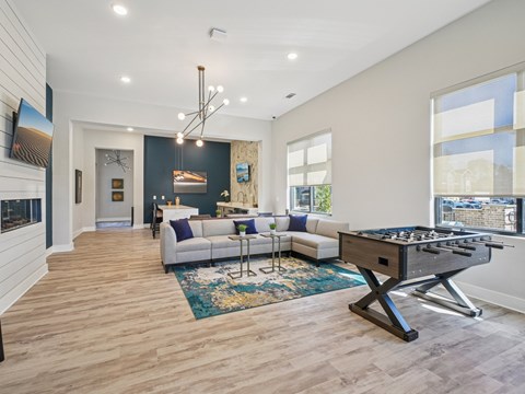 A modern living room with a pool table and a fireplace.
