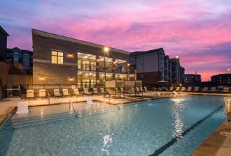 a swimming pool with a pink sunset in the background  at Ardmore at Bryton, Huntersville, North Carolina