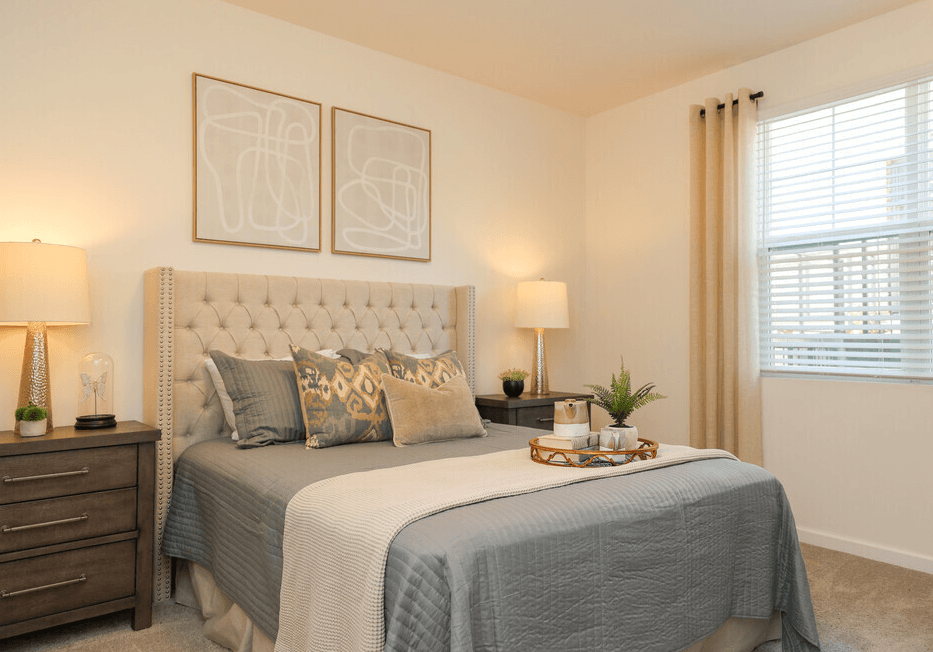 Bedroom with a bed and two lamps at Ardmore at Bryton, Huntersville