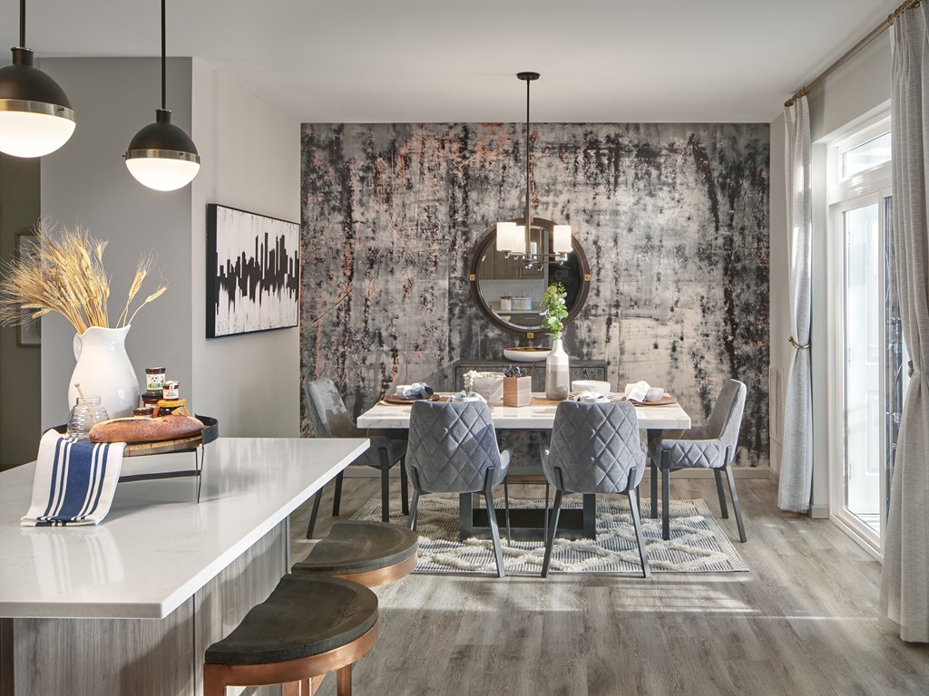 a dining room with a table and chairs and a mirror