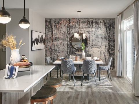 a dining room with a table and chairs and a mirror