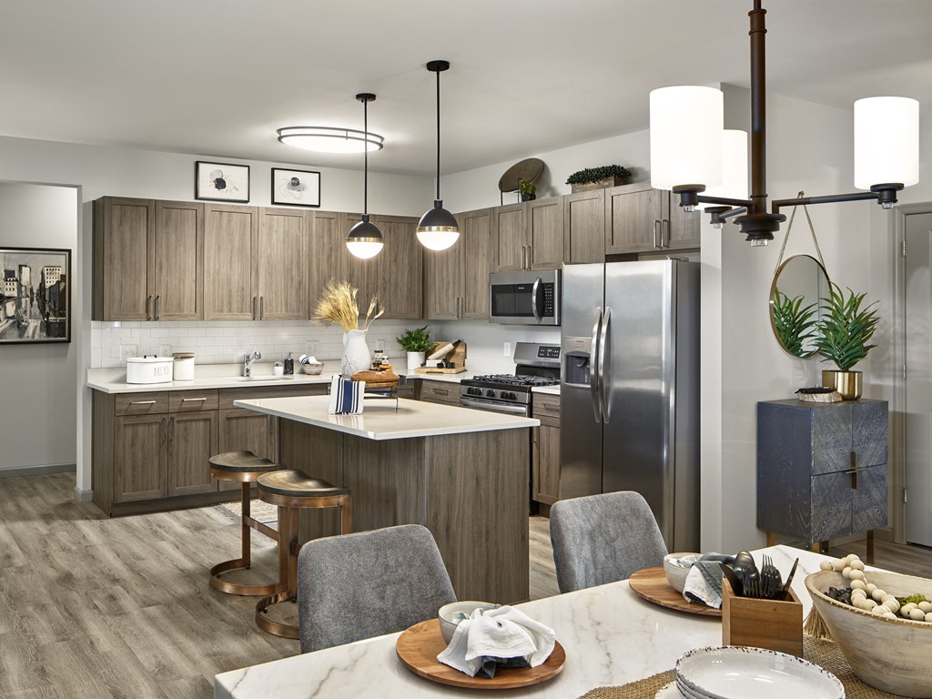 a kitchen and dining room with stainless steel appliances and wooden cabinets