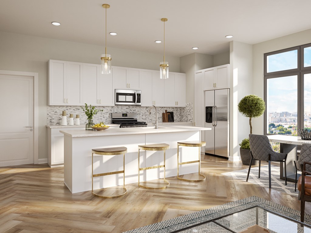 A modern kitchen with white cabinets and a central island.