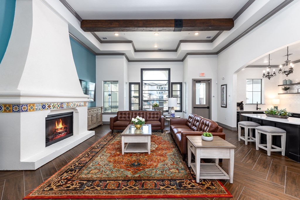 a living room with couches and tables and a fireplace
