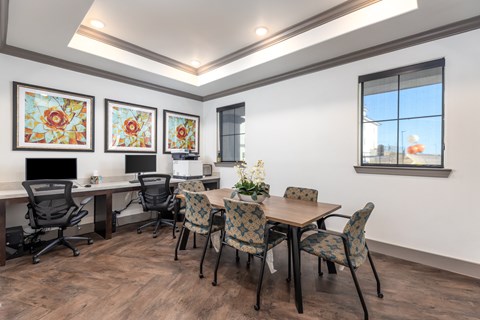 a conference room with two desks and chairs and a table with chairs