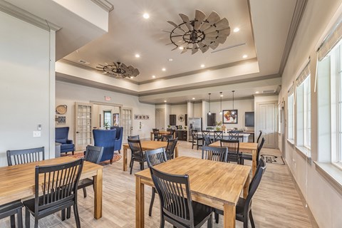 a large dining room with tables and chairs and a large window