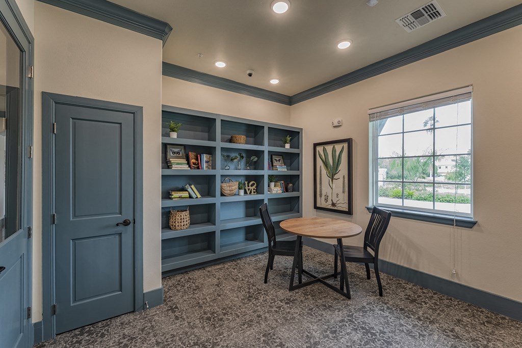 a dining room with a table and two chairs and a blue door