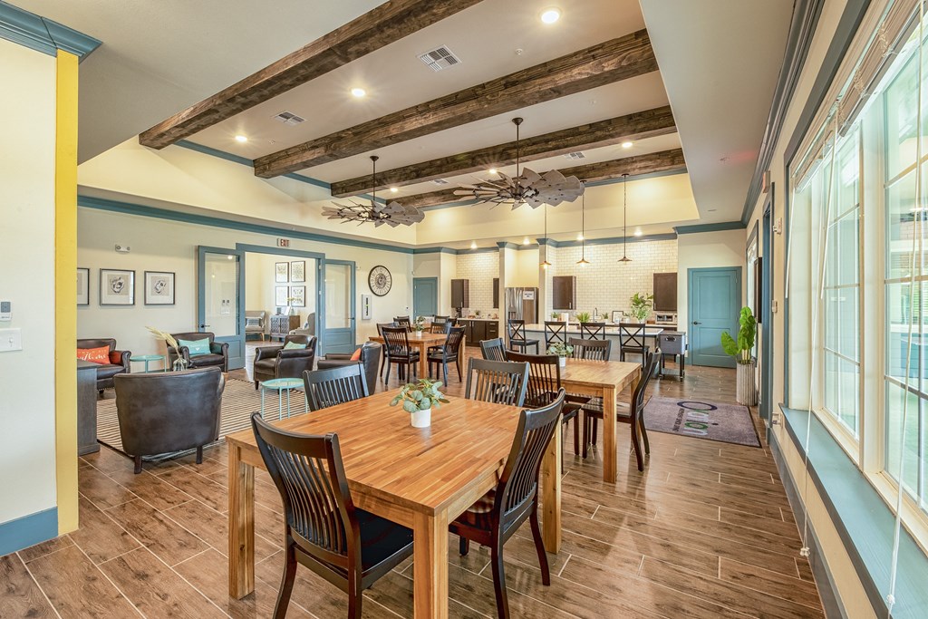 a large dining room with wooden tables and chairs