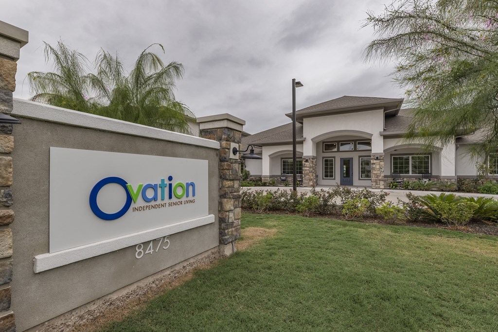 a home with an oval logo on a sign in front of it
