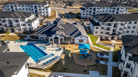 an aerial view of an apartment complex with a pool and water slides