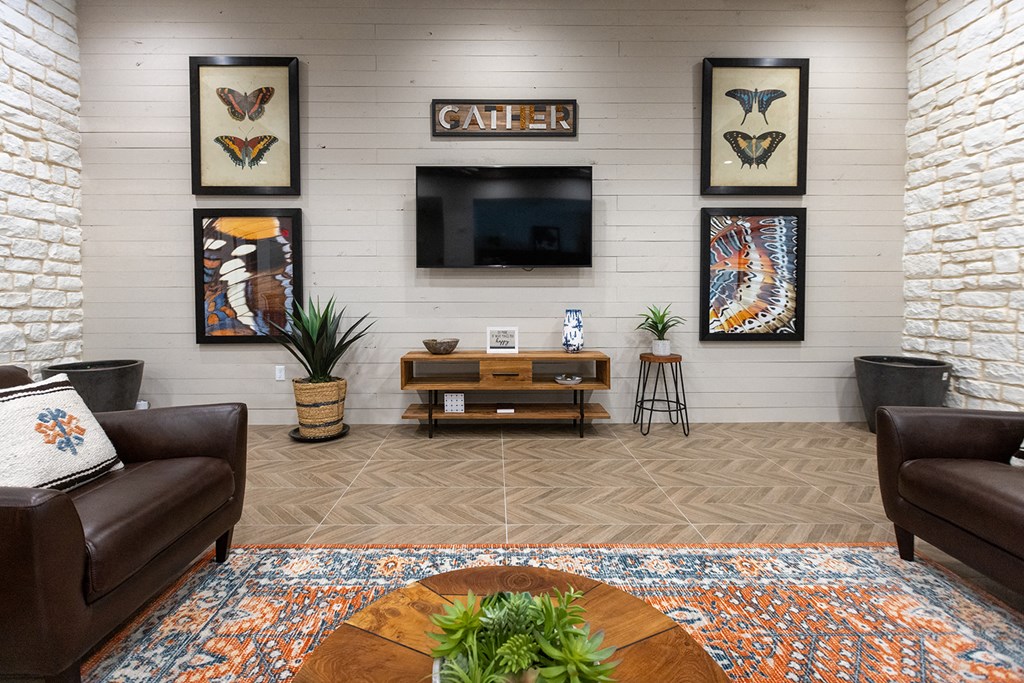 a living room with couches and a tv on the wall