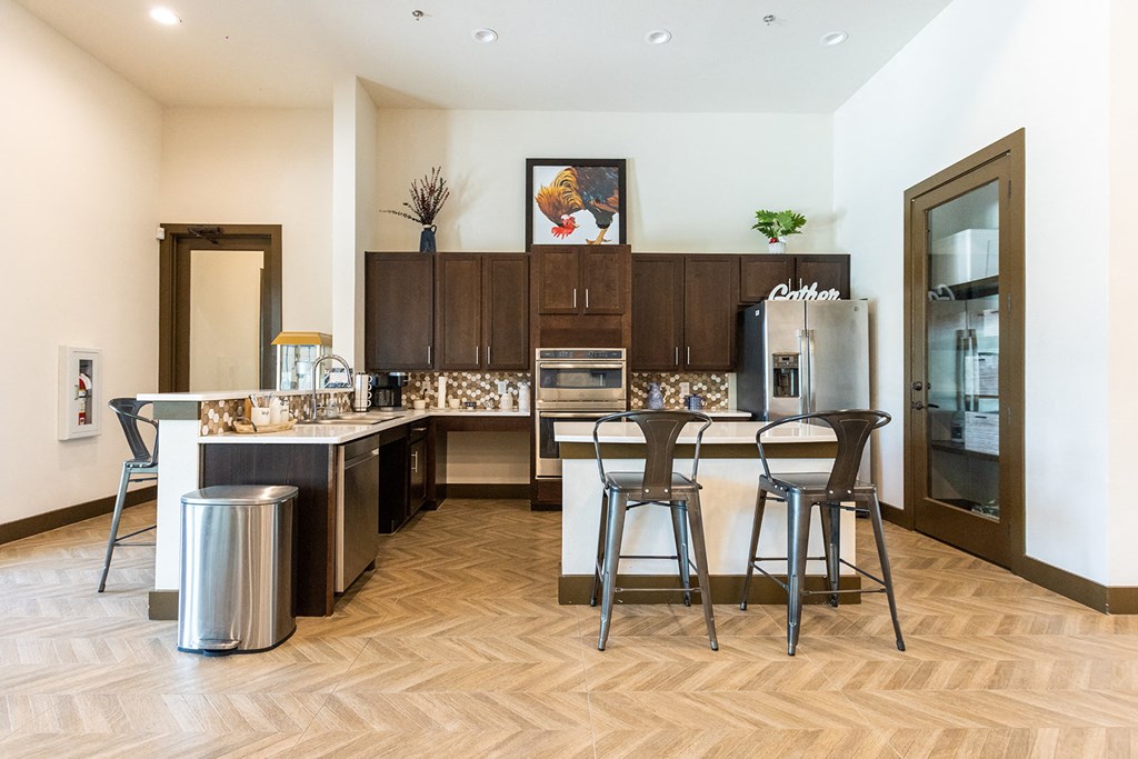 a kitchen with stainless steel appliances and a bar with stools
