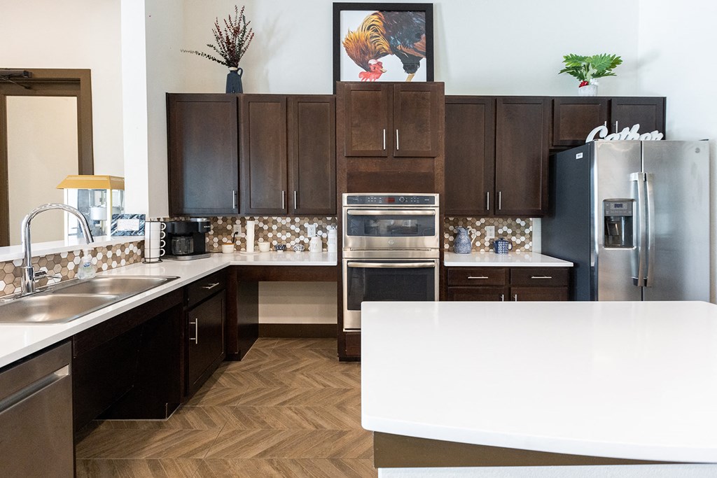 a kitchen with stainless steel appliances and a white counter top