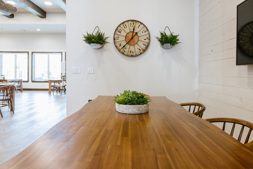 a dining room with a table and a clock on the wall