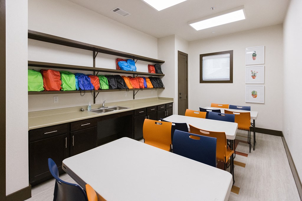 a dining room with tables and chairs and a sink