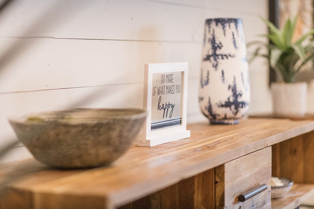 a wooden shelf with a bowl and a vase on it