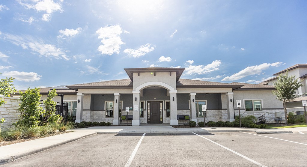 the entrance to a building with a parking lot