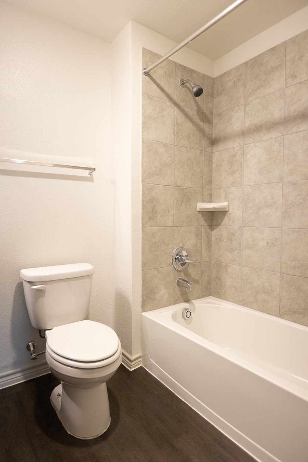 a bathroom with a toilet and a bath tub