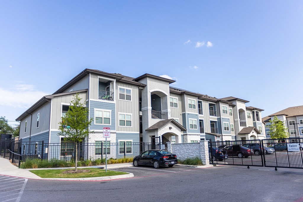 an apartment building with a car parked in front of it
