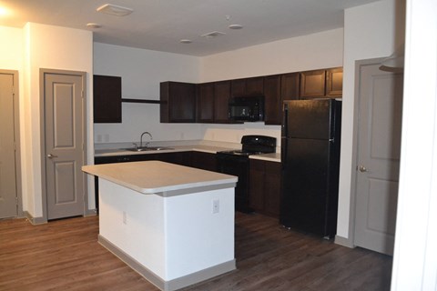 an empty kitchen with an island in the middle