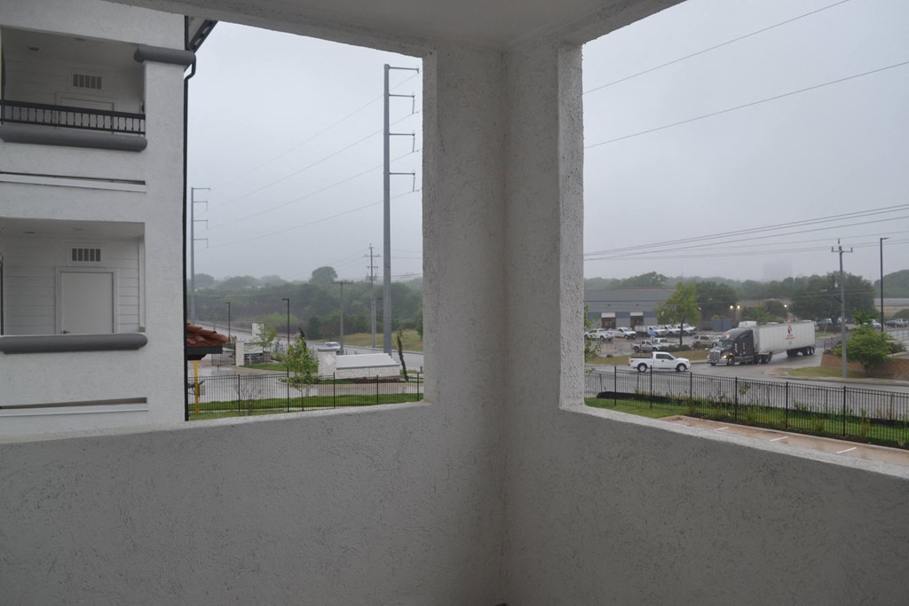 a view of the parking lot from the balcony of a building