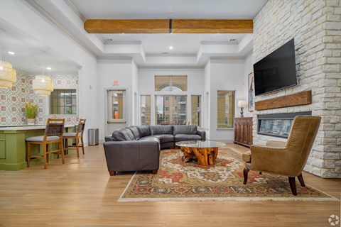 A living room with a grey couch and a wooden coffee table.