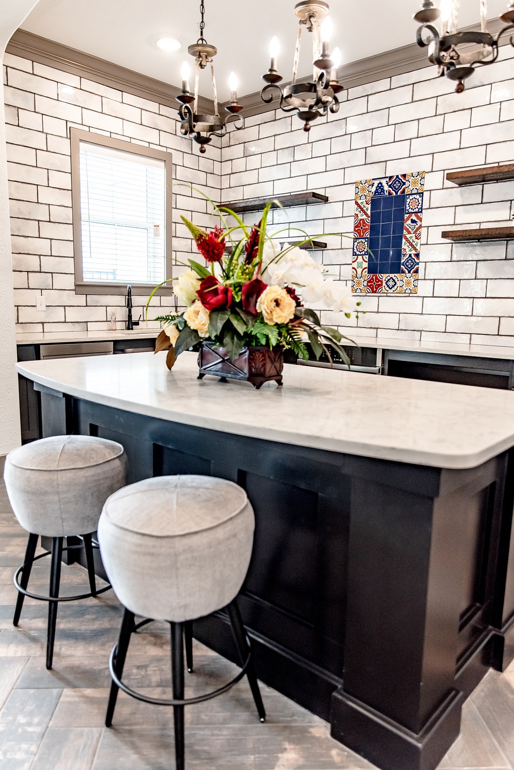a kitchen with a marble counter top and three stools