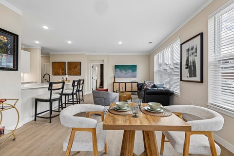 A dining room with a wooden table and chairs.