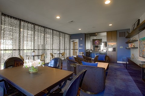 A dining room with a table and chairs.