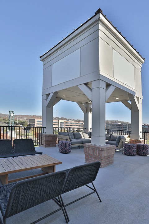 A white building with a black chair in front of it.