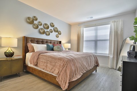 a bedroom with a bed and a large window