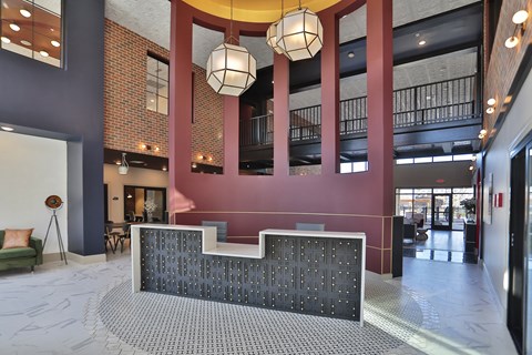 A large atrium with a staircase and a wall of windows.
