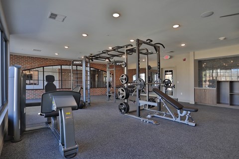 A gym with a variety of equipment including a leg press machine.