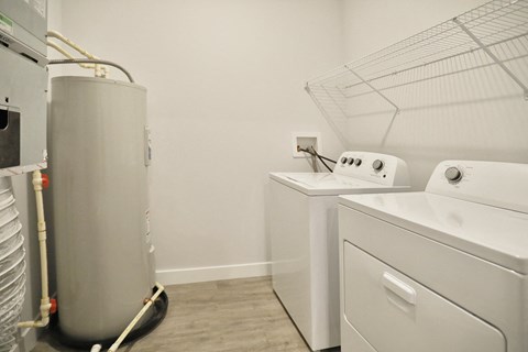a washer and dryer in a room with a washing machine and a refrigerator