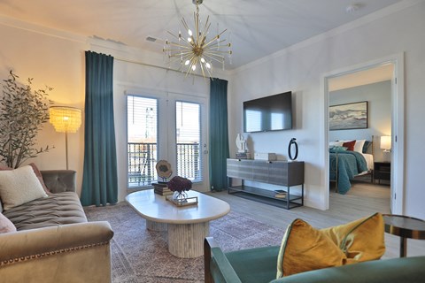 A living room with a couch, a coffee table, and a television.