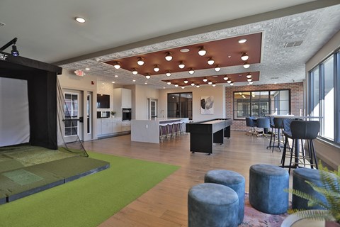A room with a green rug and a wooden floor.