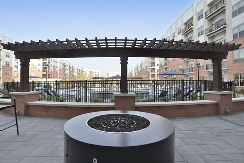 A black circular object with a design in the middle is in the foreground of a patio area.