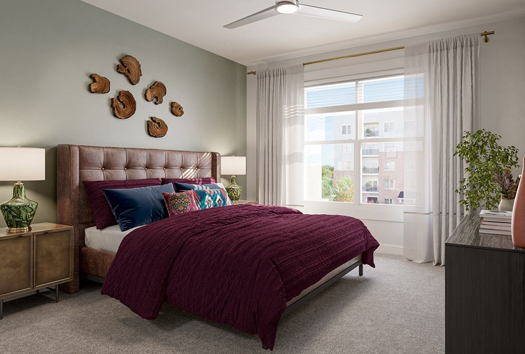 a bedroom with a bed and a large window