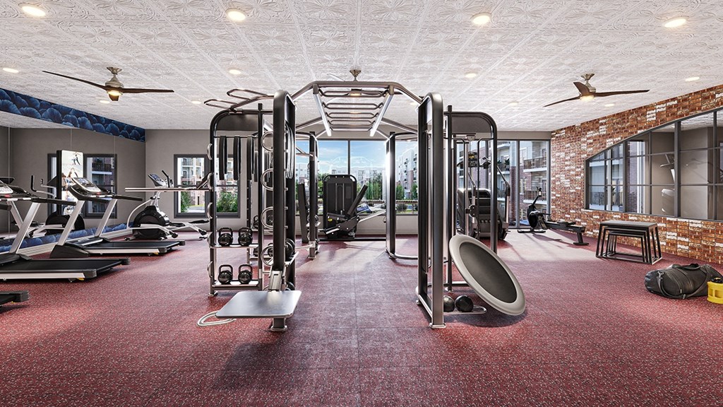 a gym with exercise equipment and a brick wall with windows