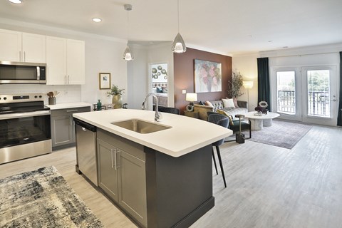 a kitchen with an island in the middle of a living room
