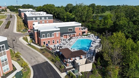 A large building with a pool in front of it.