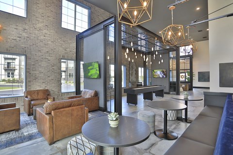 a lobby with couches tables and chairs and a large window