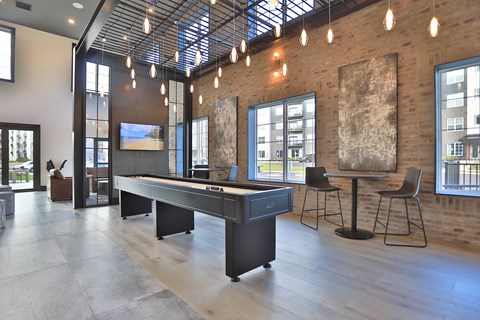 a game room with a pool table and a tv