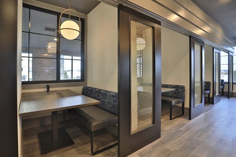 a dining area with a table and chairs and a glass door