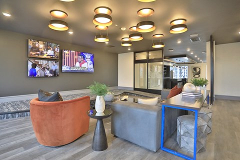 a lobby with couches and a table with a tv